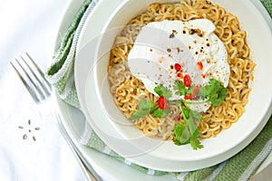 noodles in soup with poached egg