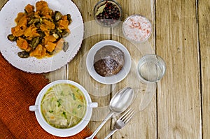 Noodles soup, vegetable stew, dinner set on table