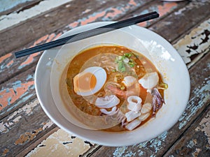 Noodles in Thai spicy tom yum soup with sea food