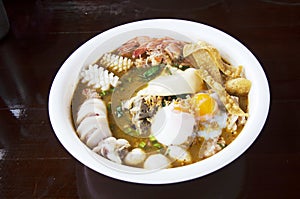 noodles tom yam soup thai style with pork and seafood and soft-boiled egg