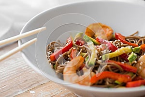 Noodles with vegetables and seafood on a wooden table Chinese-style noodles with vegetables and seafood. copy space