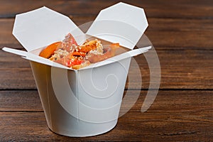 Noodles in a white box on wooden background