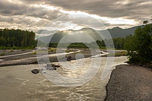 Nooksack River Sunrise. Light rays streaking across the North Cascade Mountains during a lovely sumertime sunrise.