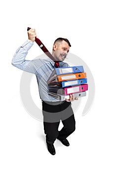 Noose around neck. Vertical portrait of young businessman, office worker with many folders isolated over white