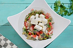 Nopal cactus salad with cheese on turquoise background. Mexican food