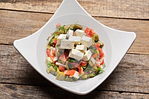 Nopal cactus salad with cheese on wooden background. Mexican food