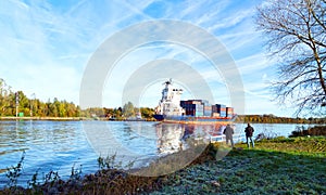 Nord-Ostsee-Kanal in autumn with container ship near Rendsburg, Germany