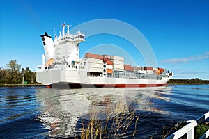 Nord-Ostsee-Kanal with passing container ship near Rendsburg, Germany