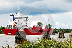 Nord-Ostsee-Kanal with red cargo ship near Rendsburg, Germany