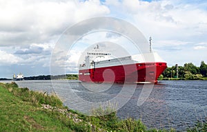 Nord-Ostsee-Kanal with red cargo ship near Rendsburg, Germany