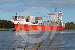 Nord-Ostsee-Kanal with red container ship near Rendsburg, Germany