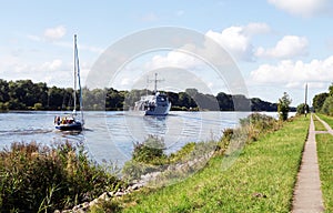 Nord-Ostsee-Kanal with sailboat and mine-hunting boat near Rendsburg, Germany