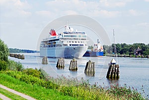 Nord-Ostsee-Kanal with white cruise ship in Oldenbuettel near Rendsburg, Germany