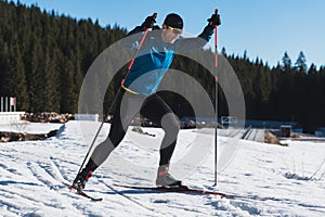 Nordic skiing or Cross-country skiing classic technique practiced by man in a beautiful panoramic trail at morning. photo