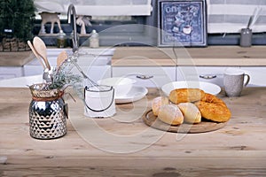 Nordic style kitchen interior with table kitchenware and croissants.