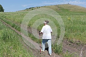 Nordic Walking - elderly woman is hiking