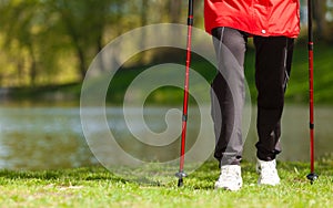 Nordic walking. Female legs hiking in the park.