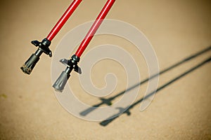 Nordic walking. Red sticks on the sandy beach