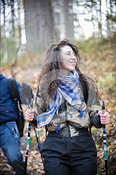 Nordic walking. Young woman and a child. Going downhill. A woman smiling