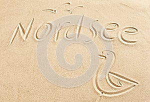Nordsee and seagull drawn in beach sand