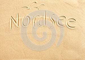 Nordsee and seagulls drawn in beach sand