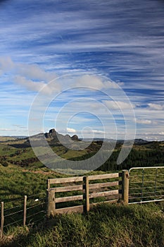 Norhtland New Zealand. Pature land with fence and gate view with blue skies and Cirrus clouds photo