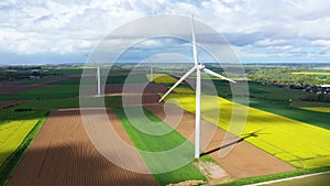 Norman wind turbines in the middle of the countryside before a storm