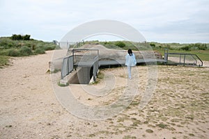 Normandie bunker from World War II with person touring