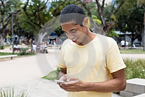 North african man sending message with phone