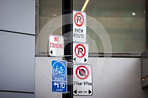 North American no parking signs and a roadsign indicating a bike lane abiding by North American standard in Toronto, Canada. photo