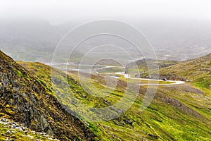 North Cape Nordkapp, on the northern coast of the island of Mageroya in Finnmark, Northern Norway on heavy foggy day .