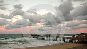 A North Carolina pier and beach at sunset