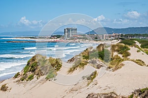 Dunes on FÃÂ£o beach with Atlantic Ocean waves and Esposende architecture in the background, PORTUGAL photo