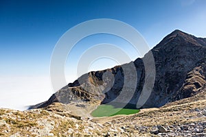 The north-est face of Mont Mucrone and the Mucrone lake in a sun