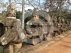 Statues on the North Gate to Angkor Thom photo