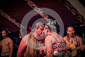 NORTH ISLAND, NEW ZEALAND- MAY 17, 2017: Tamaki Maori couple dancing with traditionally tatooed face in traditional