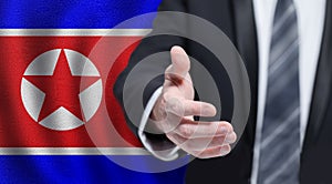 North Korea politics concept. Hand on flag of North Korea background