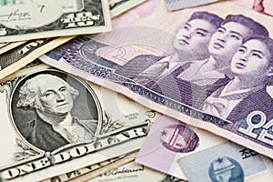 North Korea Won and US Dollar banknotes.