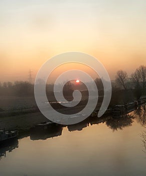 North London canal with canal boats moored in this winter morning sun rise