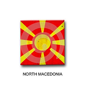 North Macedonia flag on a wooden block. Isolated on white background. Signs and symbols.