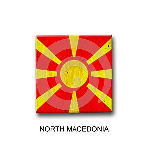 North Macedonia flag on a wooden block. Isolated on white background. Signs and symbols