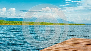 North macedonia. Ohrid. Ohrid lake in sunny day with reeds, pier and mountaines on background