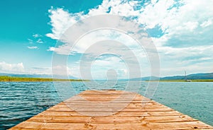 North macedonia. Ohrid. Wood pier in Ohrid lake in sunny day with reeds, pier and mountaines on background
