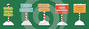 North Pole Signboards and Christmas Wooden Street Signs set in Snow, Winter Pointers with Garlands, Snow, and Striped