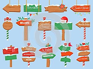 North pole signs. Christmas wooden street signboad with snow. Arrow signpost direction to Santa workshop. Winter holiday