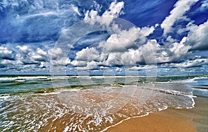 The north sea beach with clouds and  sun , wide angle view of the nordsea