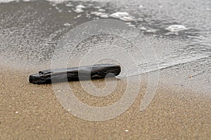 North sea beach with cloudy day with waves on the shore and village