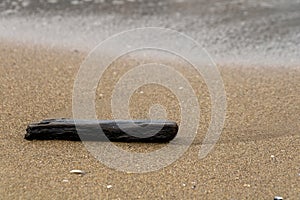 North sea beach with cloudy day with waves on the shore and village