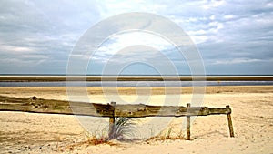 North-sea beach with wooden fencing photo