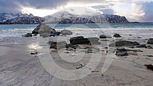 Rocks on Ramsberg beach on Flakstad island on the Lofoten islands in winter at sunset photo